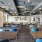 Dining hall at our active adult community in New Braunfels, TX, featuring wood grain floor paneling and dining tables.