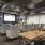 The theater room at our active adult community in New Braunfels, featuring cushioned chairs in front of a flat screen TV.