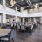 Dining hall at our active adult community in New Braunfels, TX, featuring wood grain floor paneling and dining tables.